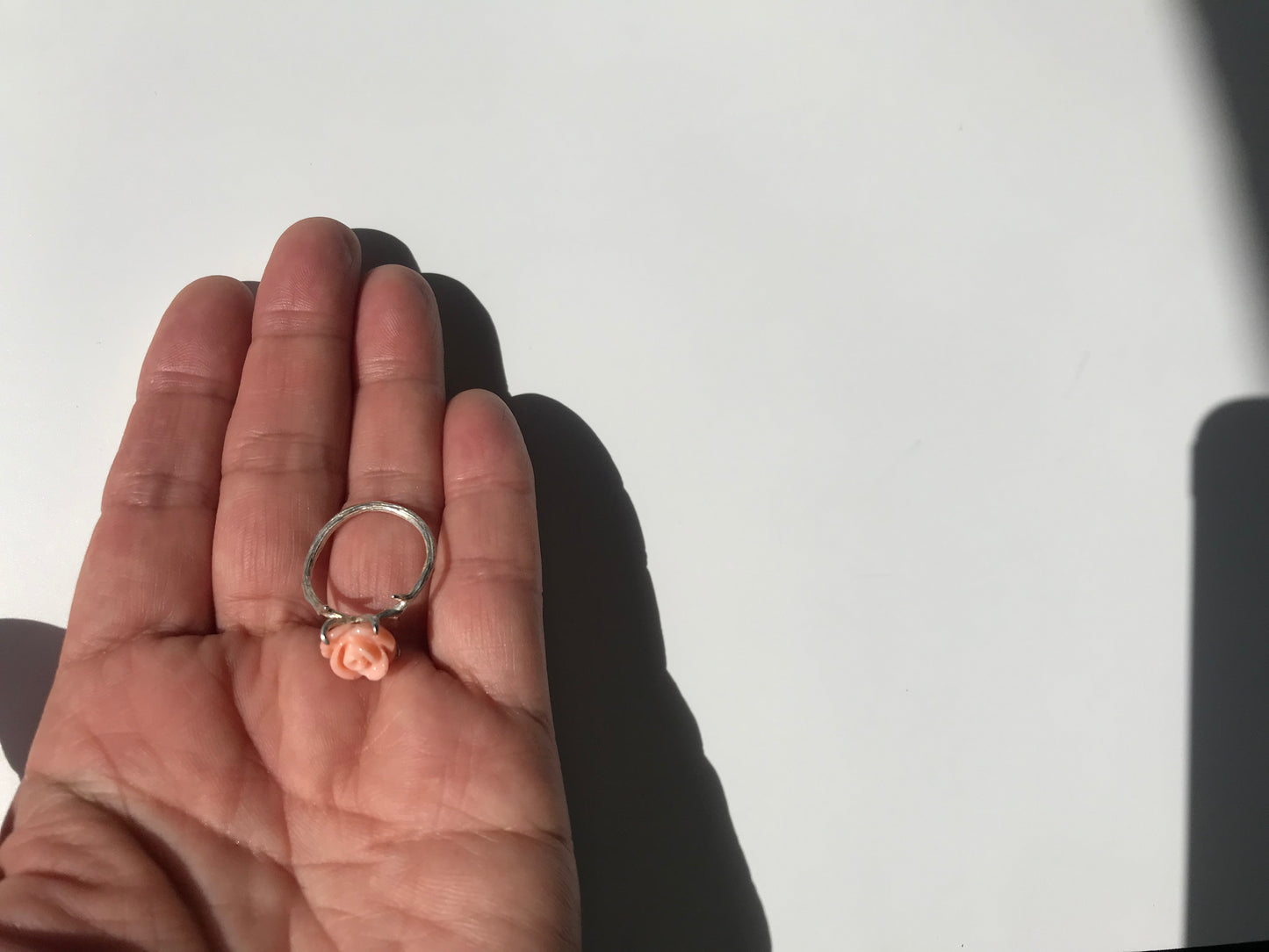 Carved angel skin coral rose ring with silver thorns