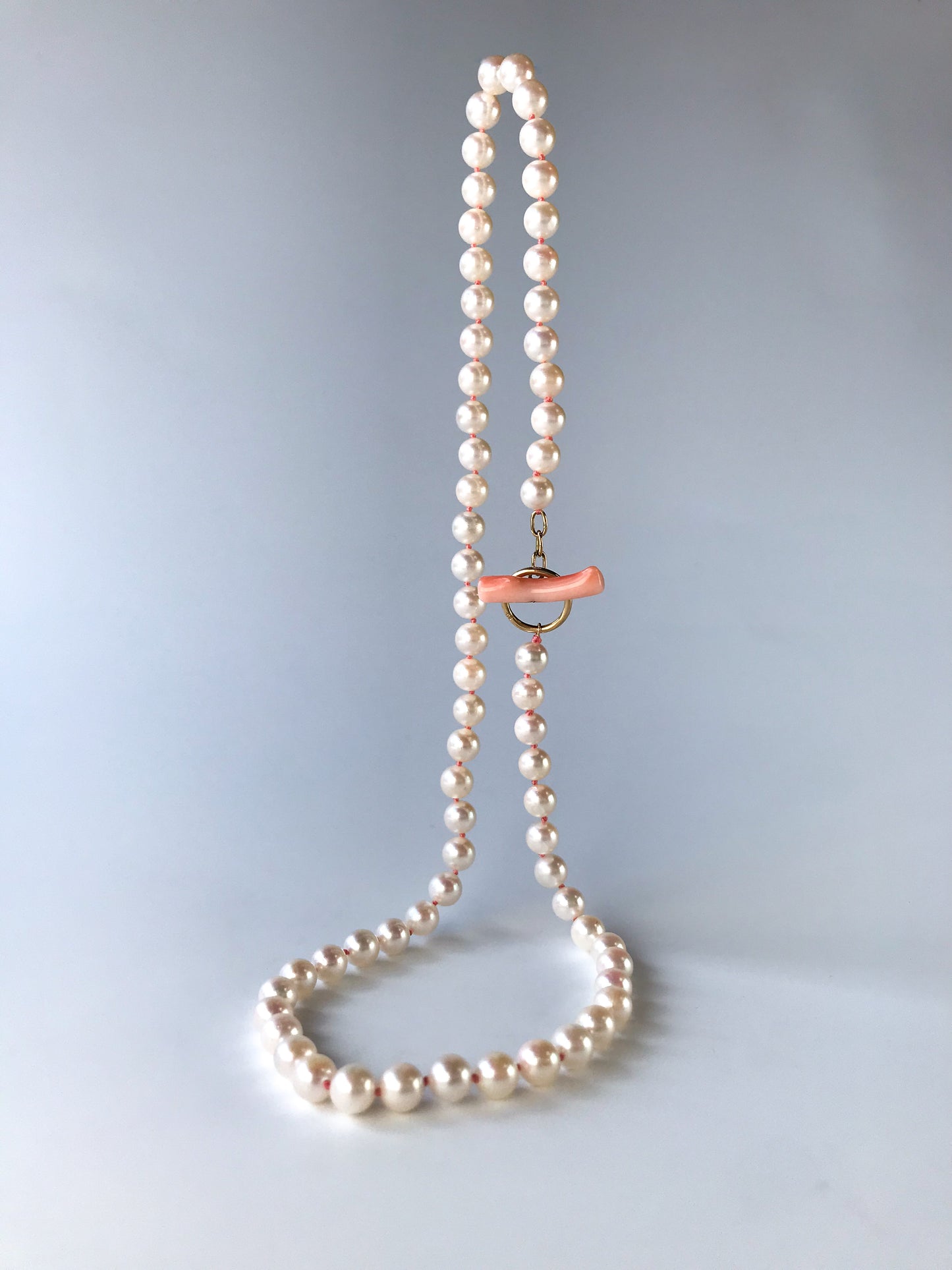 K18 Akoya pearl necklace with pink deep sea coral bar