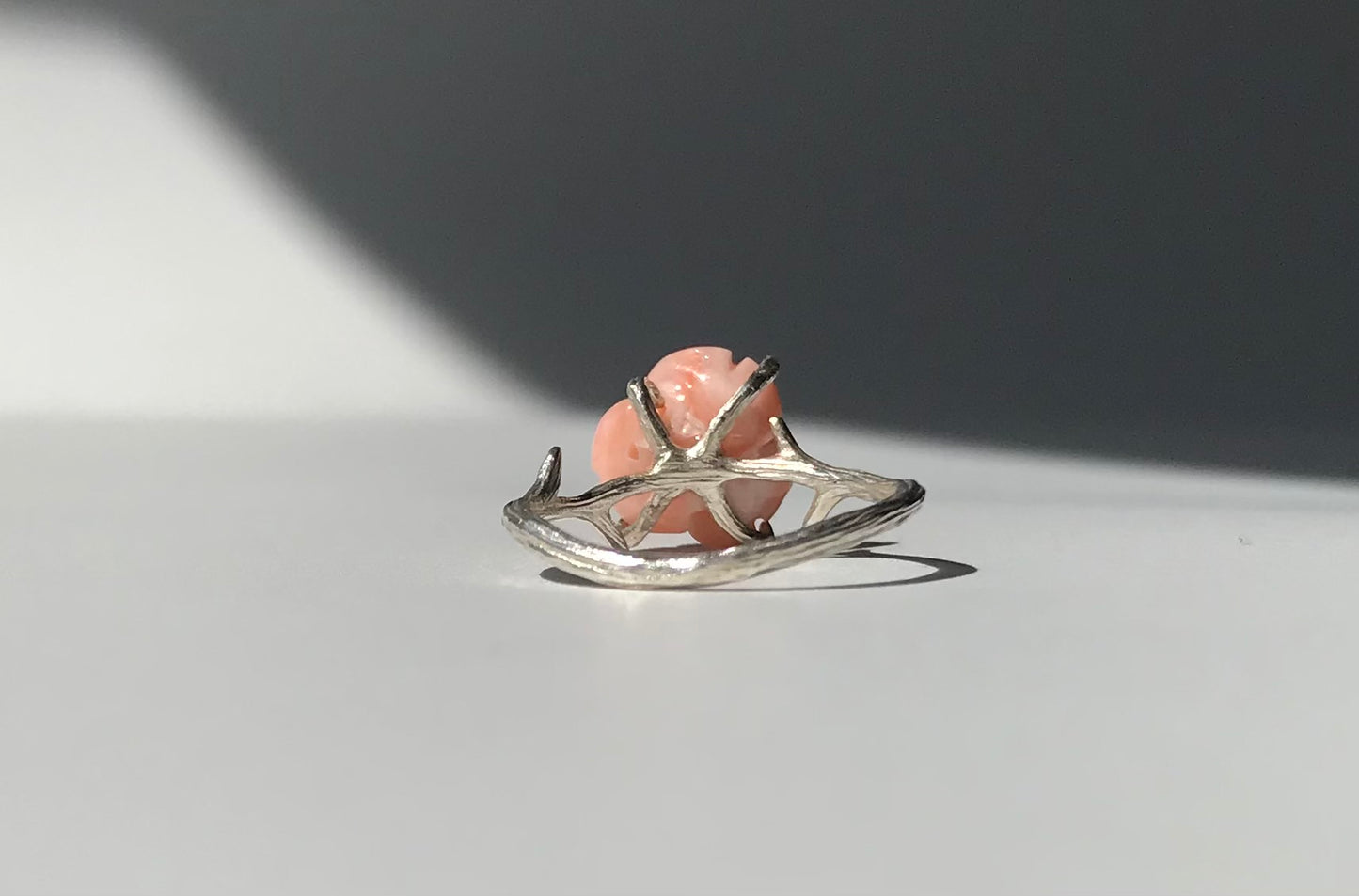 Carved angel skin coral rose ring with silver thorns