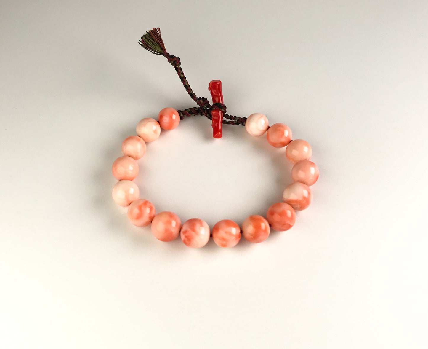 Large coral beads and silk Kumihimo bracelet