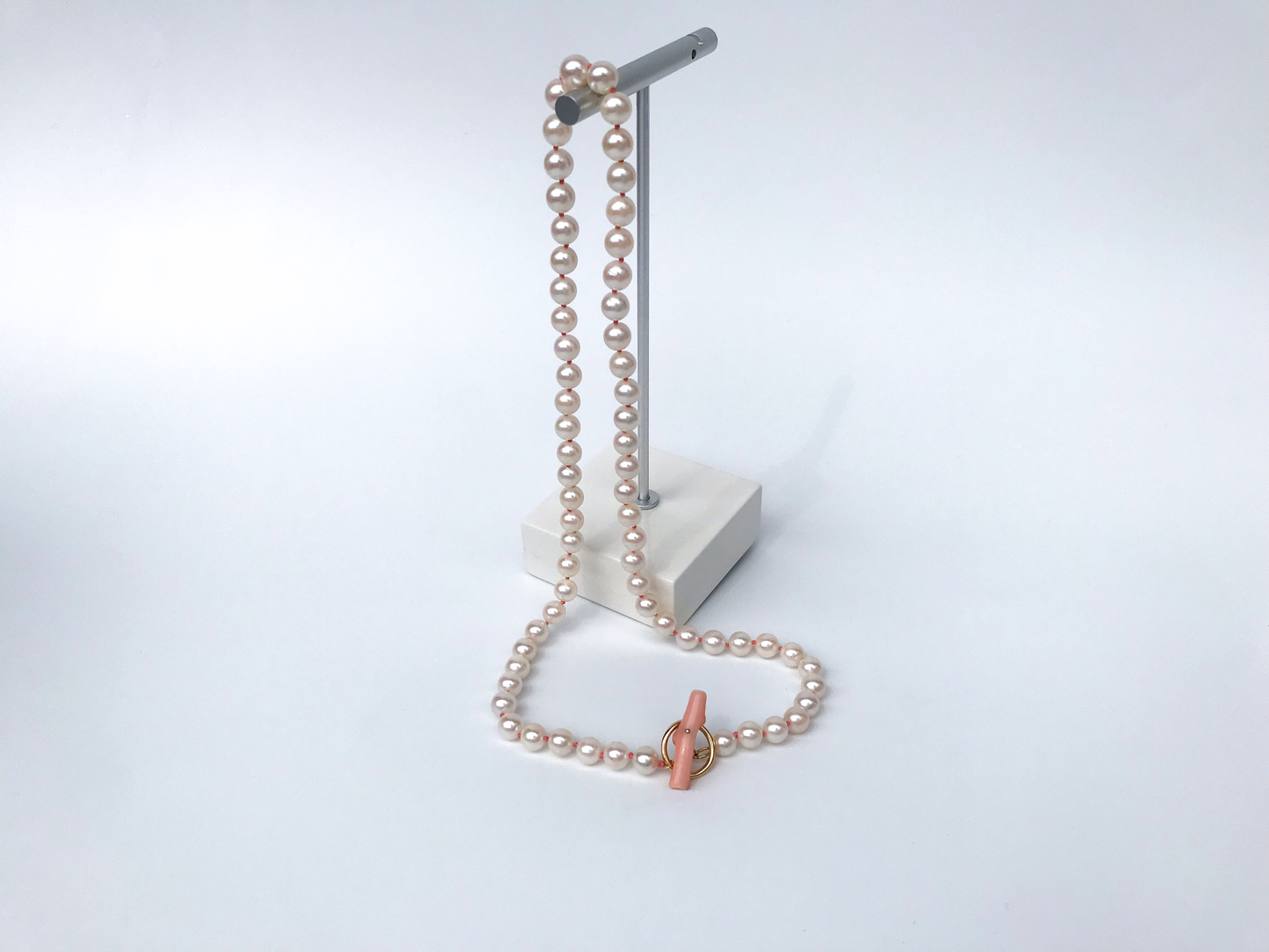 K18 Akoya pearl necklace with pink deep sea coral bar