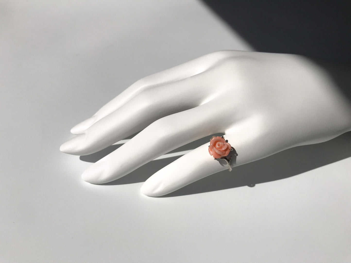 Carved angel skin coral rose ring with silver thorns