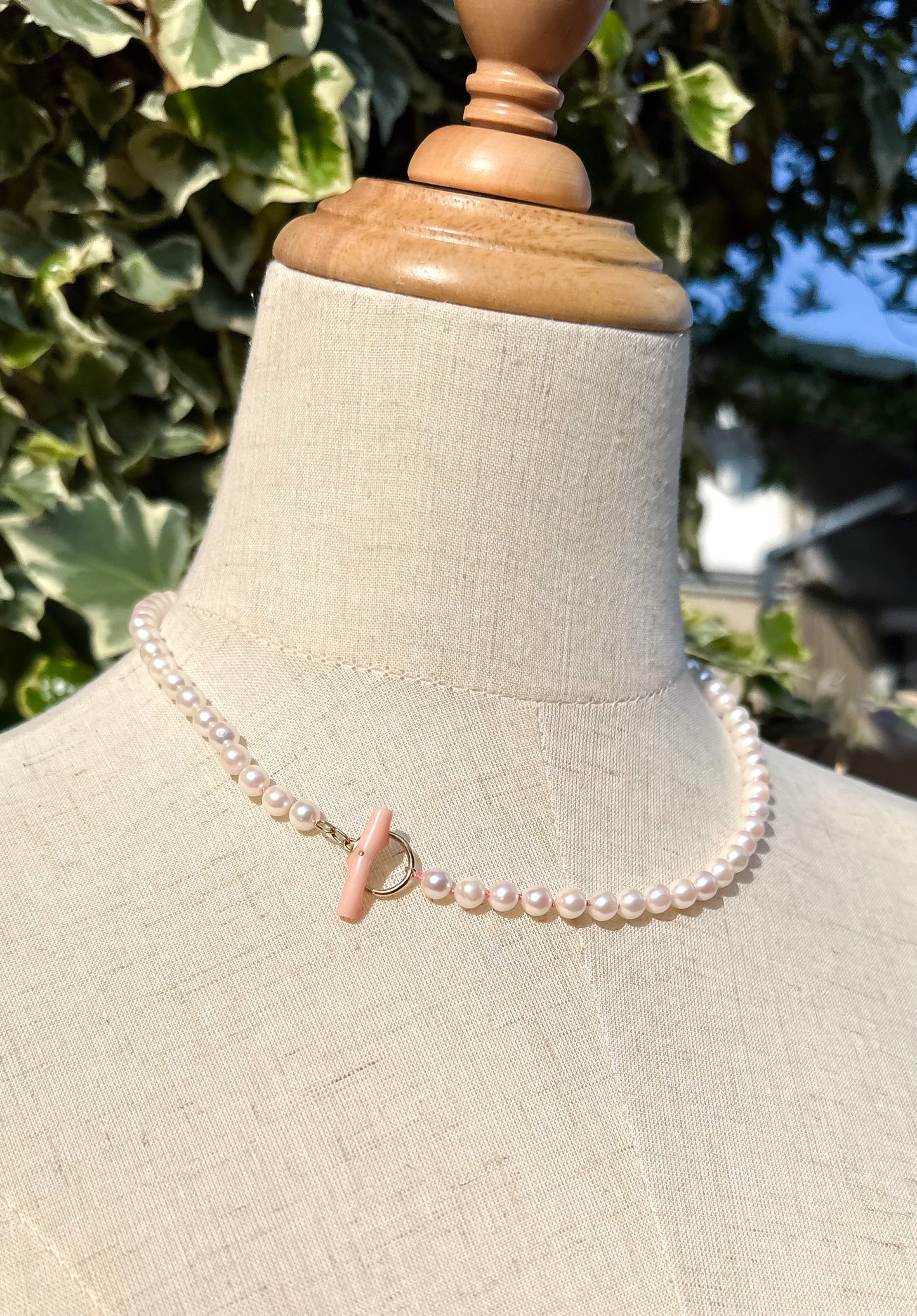 K18 Akoya pearl necklace with pink deep sea coral bar